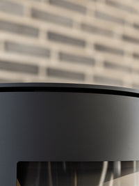 Side view of Aduro 17 wood burning stove showcasing clean lines and large glass panels for a 180-degree flame view.