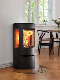 Side view of Aduro 17 wood burning stove showcasing clean lines and large glass panels for a 180-degree flame view.