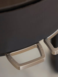 Side view of the Aduro 23 wood burning stove showcasing its curved glass and elegant legs in a modern design.