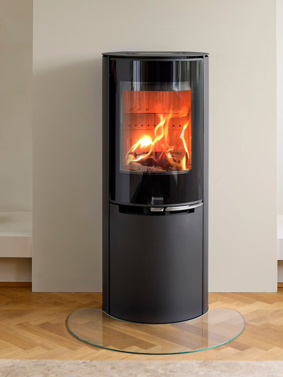 Aduro 9.8 Lux wood burning stove with black glass door, curved front, and integrated handles, showcasing elegant design.