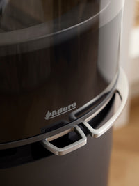 Side view of Aduro 9.8 Lux wood burning stove with black glass door and integrated handles, showcasing its elegant design.
