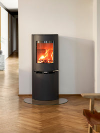 Side view of Aduro 9.8 Lux wood burning stove with black glass door and integrated handles, showcasing elegant design.