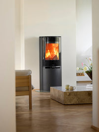 Side view of the Aduro 9.8 Lux wood burning stove with black glass door and integrated handles, showcasing its elegant design.