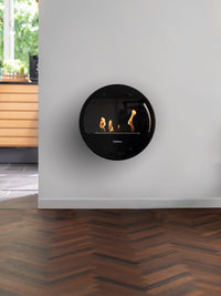 Side view of Aduro B1 bioethanol fireplace with elegant glass door and sides, showcasing its sleek Danish design.