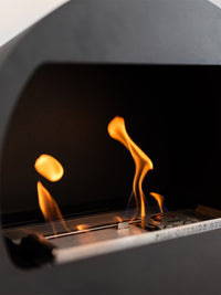 Side view of Aduro B2 bioethanol fireplace showcasing its open front and sleek design in a modern living room setting.