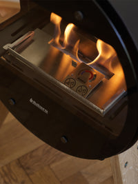 Side view of Aduro B2 bioethanol fireplace showcasing its sleek design and open front for warmth and ambiance.