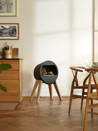 Side view of Aduro B2 bioethanol fireplace showcasing its sleek design and open front for warmth and ambiance.