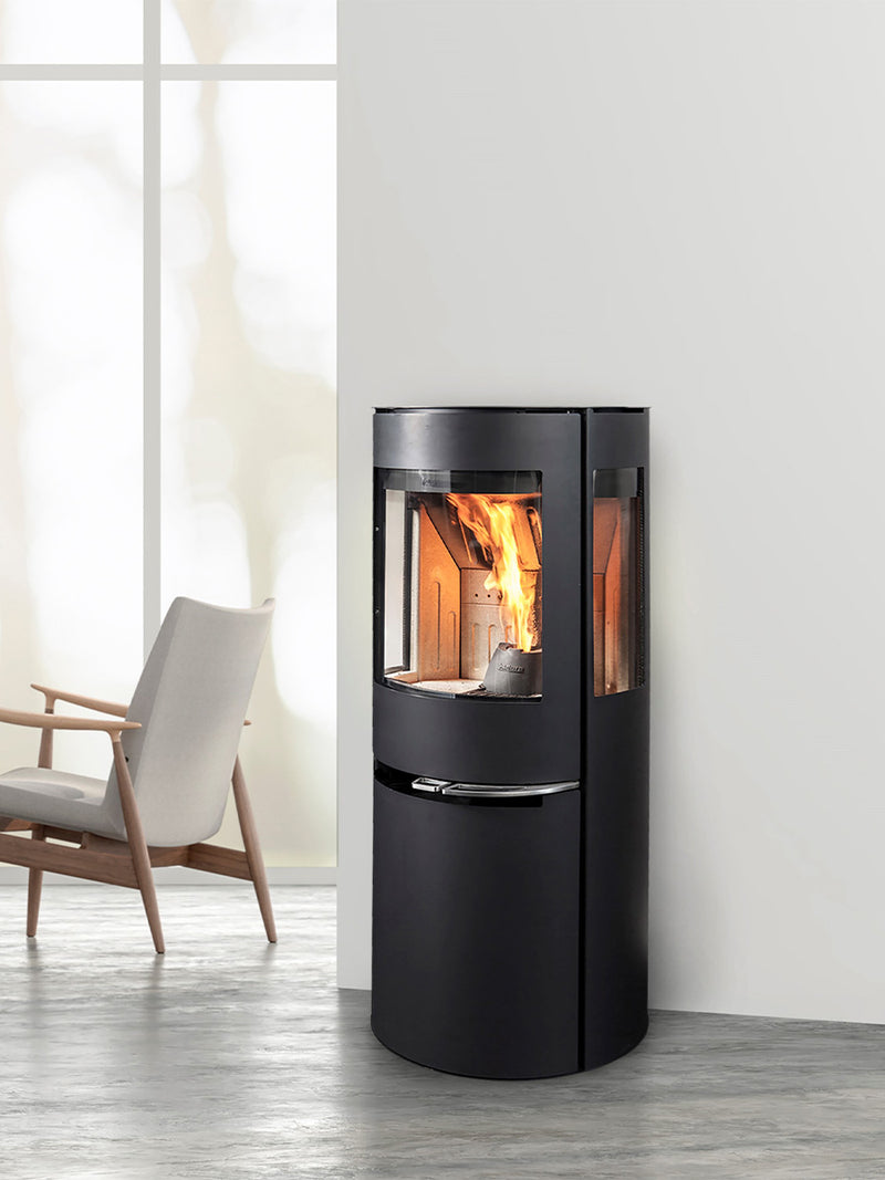 Aduro H1 Hybrid Stove with large glass front, showcasing flames, sleek black design, and pellet container underneath.