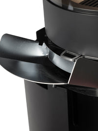Side view of Aduro H1 Hybrid Stove showcasing large glass area and sleek black design with wood and pellet options.