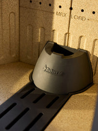 Side view of Aduro H1 Hybrid Stove with large glass area showcasing flames, black metal finish, and pellet container.