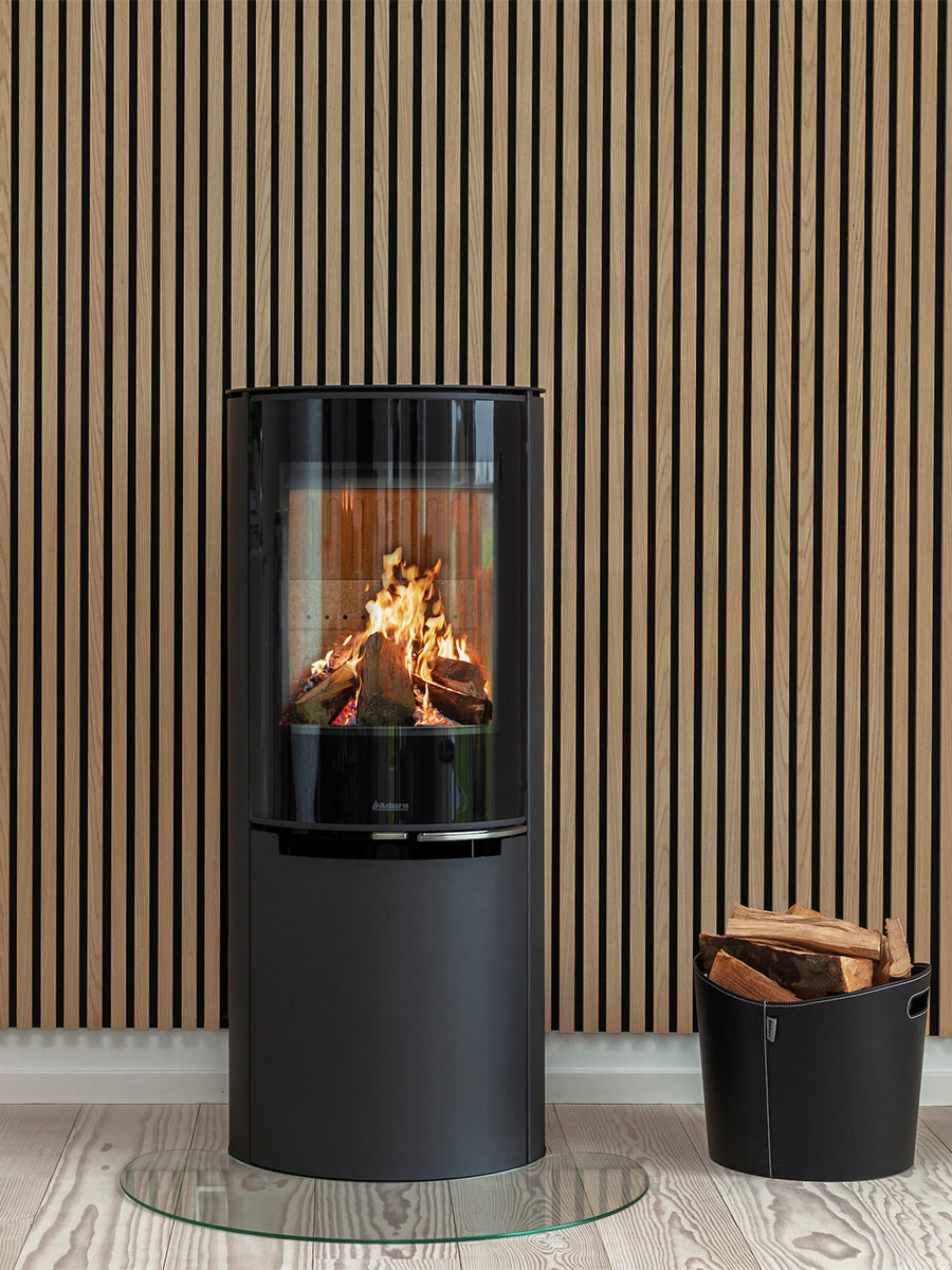 Elegant Aduro H4 Lux Hybrid Stove with glossy glass door and curved front, suitable for wall or corner installation.