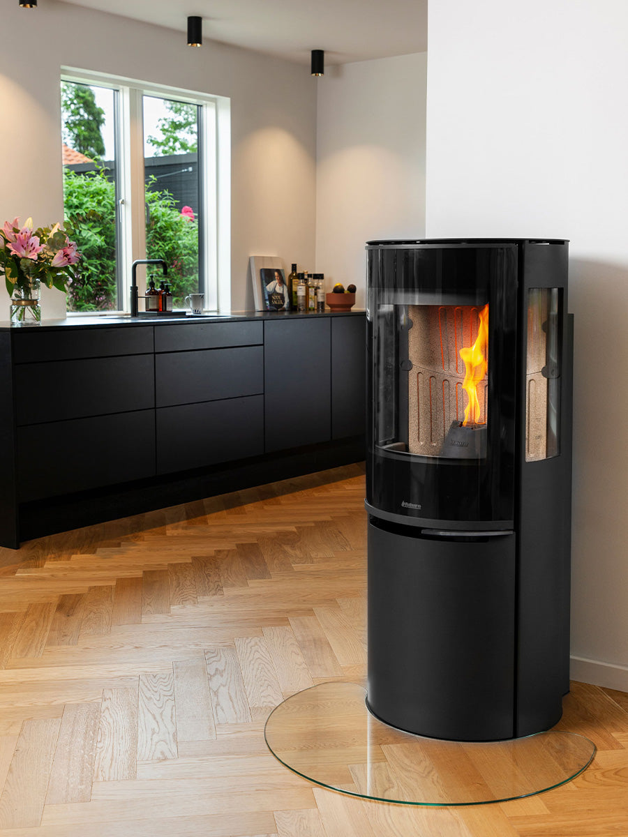 Aduro P5 Lux wood pellet stove in sleek black with a modern design, showcasing the front view and glass door.