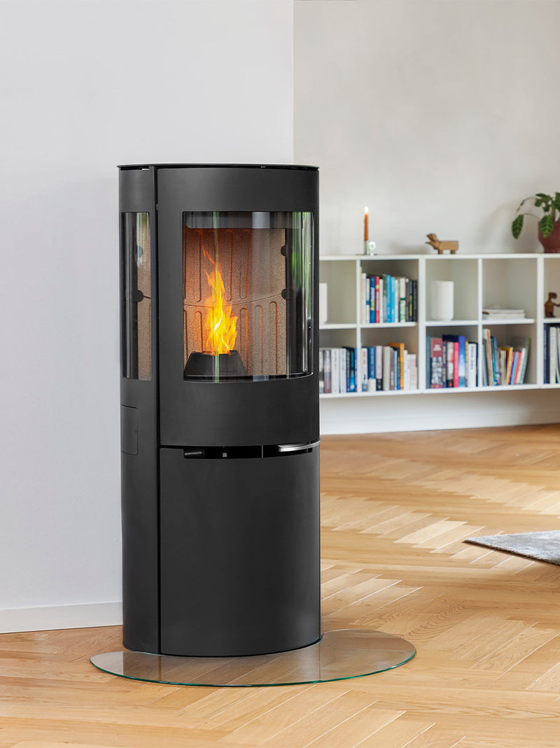 Aduro P5 wood pellet stove with curved glass and elegant side panels, showcasing a 180-degree flame view.