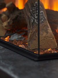 Side view of the British Fires Brockenhurst electric fire suite, showcasing its sleek design and three-sided glass viewing.
