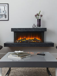 Side view of the British Fires Brockenhurst electric fire suite, showcasing its sleek design and three-sided glass viewing.