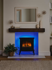 Side view of the British Fires Hinton Electric Stove showcasing its cast iron body and hand-scorched oak logs.
