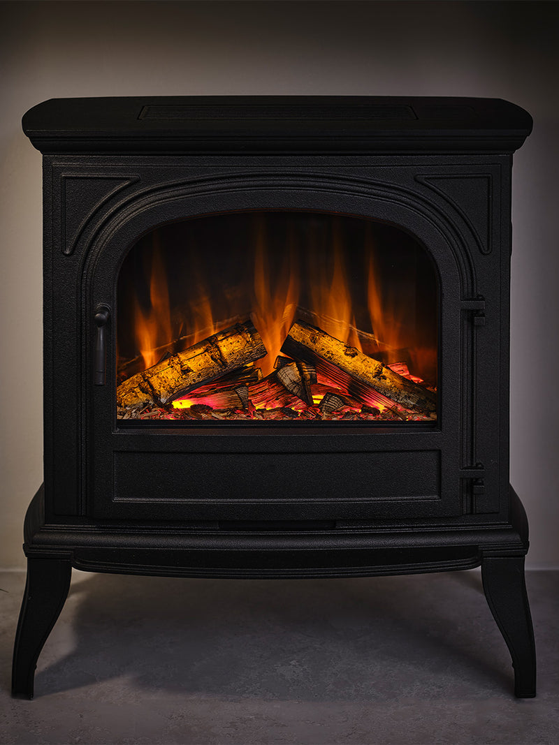 British Fires Hinton Electric Stove in cast iron with hand-scorched oak logs and LED mood lighting in orange.
