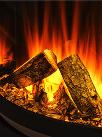 Side view of the British Fires Sway 16" electric fire in a sleek black frame, showcasing its contemporary design.