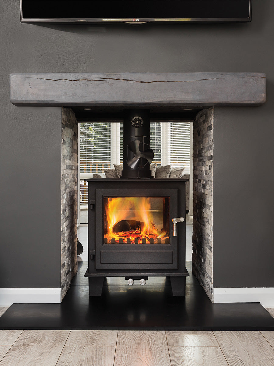 Double-sided wood burner in sleek black with glass panels, showcasing modern design and multi-fuel capability.