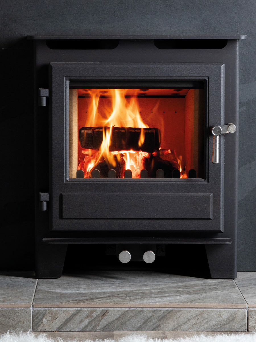 Blithfield inset wood burner in sleek black finish, recessed into a stylish wall for a modern, integrated look.