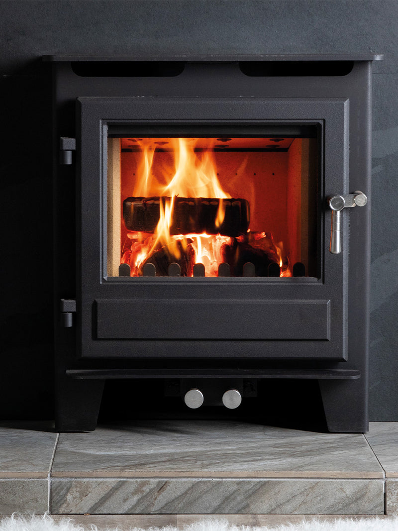 Blithfield inset wood burner in sleek black finish, recessed into a stylish wall for a modern, integrated look.