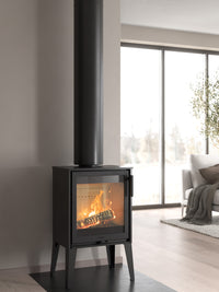 Side view of the Contura 210 wood burning stove with a classic cast iron door and sleek design, showcasing its compact size.