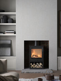 Side view of the Contura 210 wood burning stove with a classic cast iron door and sleek design, showcasing its compact size.