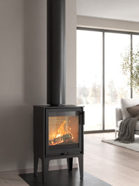 Side view of the Contura 210 wood burning stove with a classic cast iron door and sleek design, showcasing its compact size.