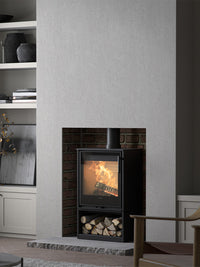 Side view of the Contura 210G wood burning stove with a sleek glass door and modern design, showcasing its compact size.
