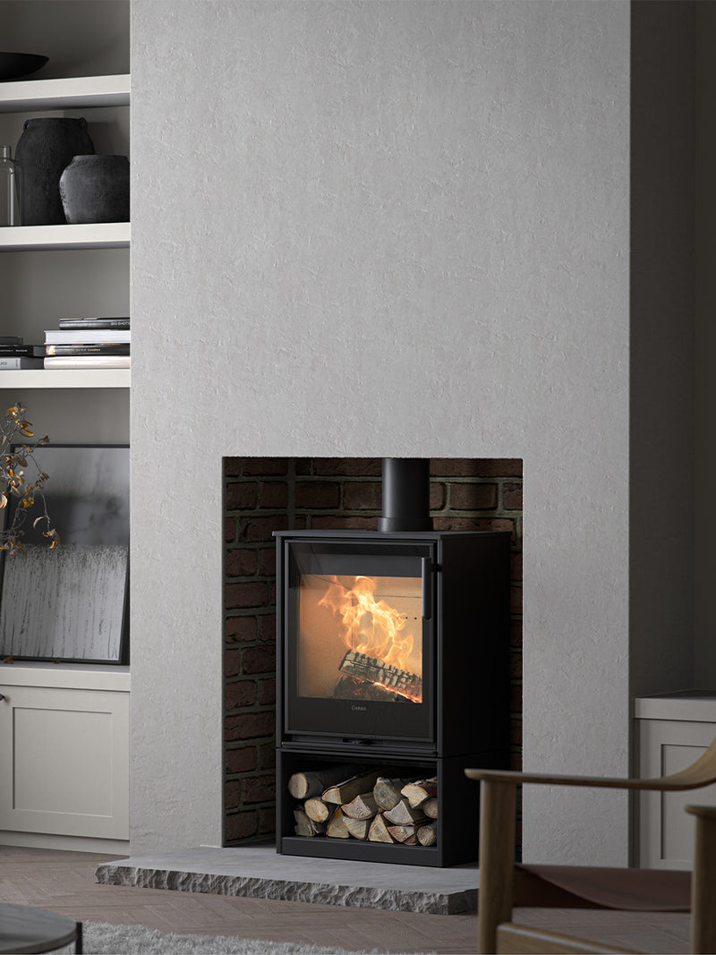 Side view of the Contura 210G wood burning stove with a sleek glass door and modern design, showcasing its compact size.
