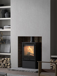 Side view of the Contura 210G wood burning stove with glass door, showcasing its sleek design and compact size.