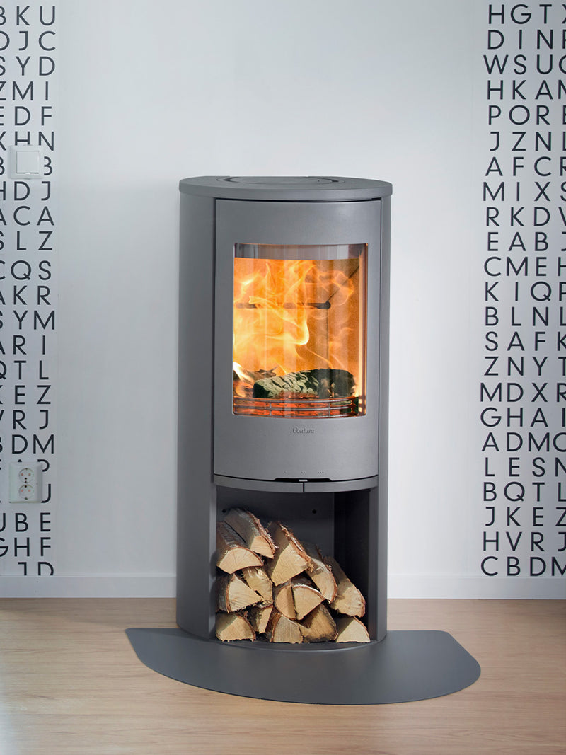 Side view of the Contura 510 wood burning stove, showcasing its cast iron door and large side lights.