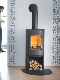 Contura 510 wood burning stove with cast iron door, large side lights, and curved design in a cozy living room setting.