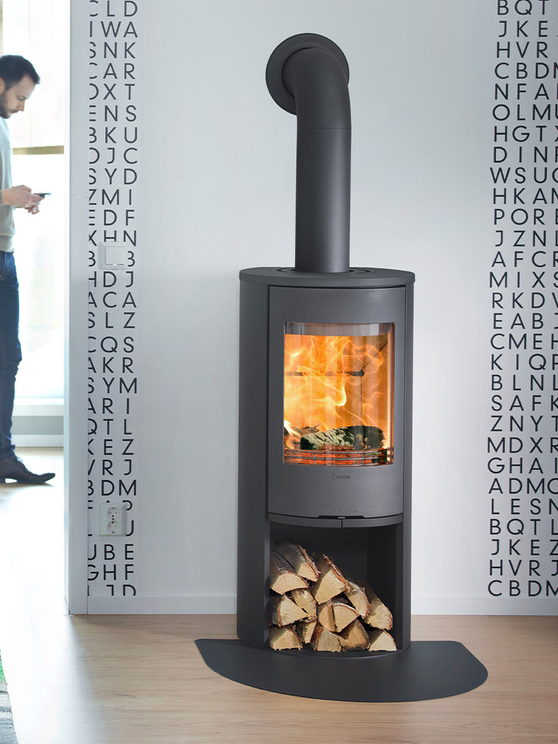 Contura 510 wood burning stove with cast iron door, large side lights, and curved design in a cozy living room setting.