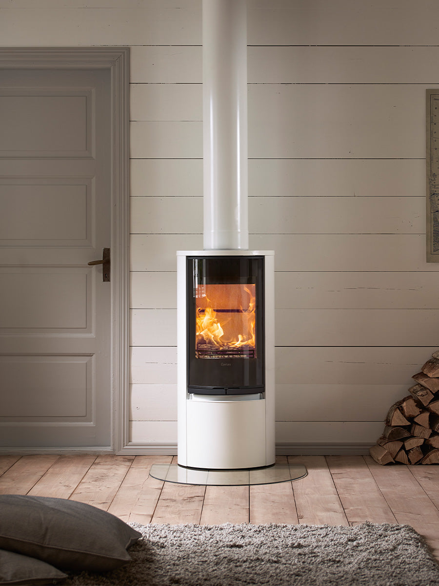 Contura 510G wood burning stove with large glass door, showcasing sleek design and curved proportions in a modern setting.