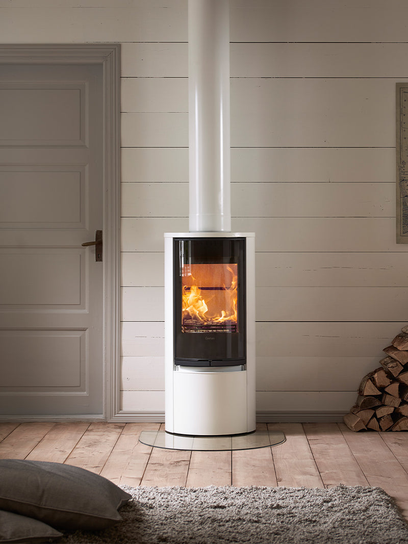 Contura 510G wood burning stove with large glass door, showcasing sleek design and curved proportions in a modern setting.