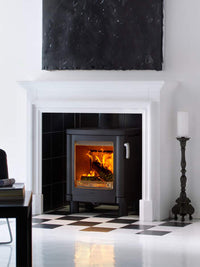 Side view of the Contura 51L wood burning stove with a modern cast iron door and clean lines, showcasing its sleek design.