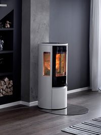 Side view of the Contura 556G wood burning stove with a sleek black finish and large glass door, showcasing its modern design.
