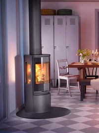 Side view of the Contura 556G wood burning stove with a sleek black finish and large glass door, showcasing its modern design.