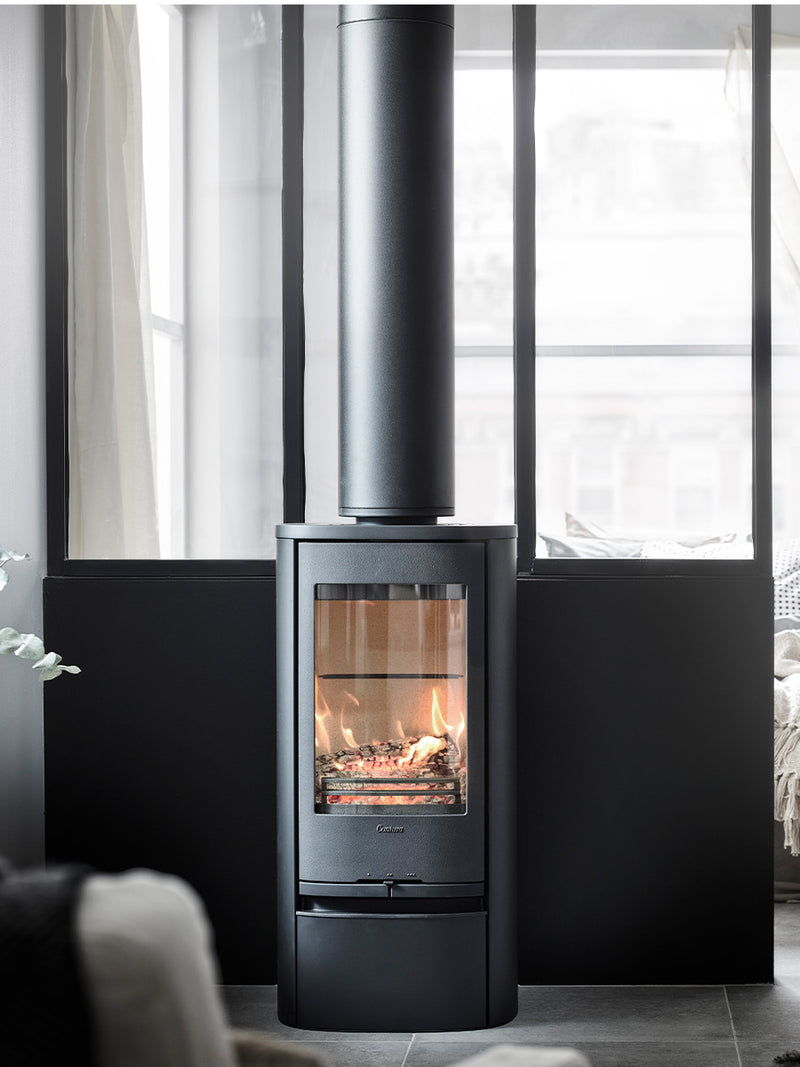 Contura 810 wood burning stove in black cast iron with classic door, showcasing its elegant design and height.