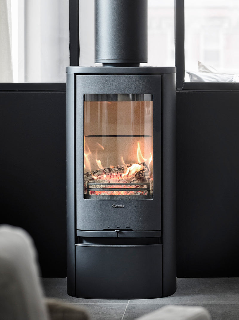 Side view of the Contura 810 wood burning stove in black, showcasing its cast iron door and sleek design.