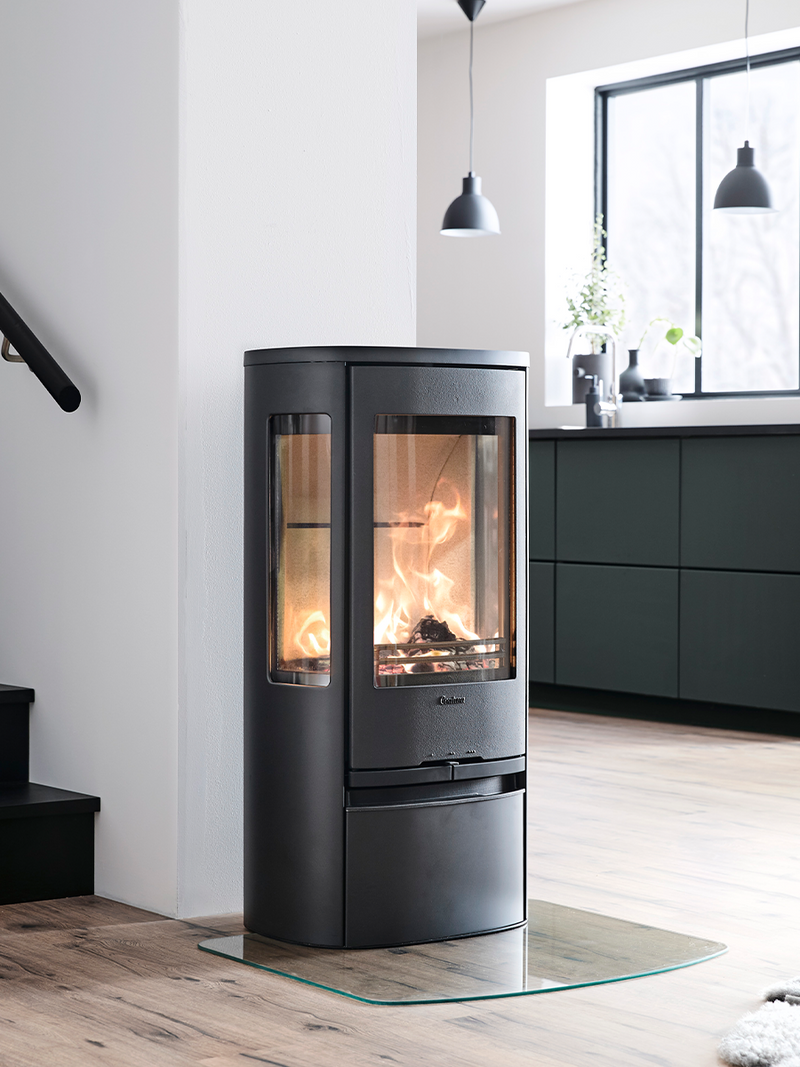 Side view of the Contura 856 wood burning stove showcasing its cast iron door and generous side panes.