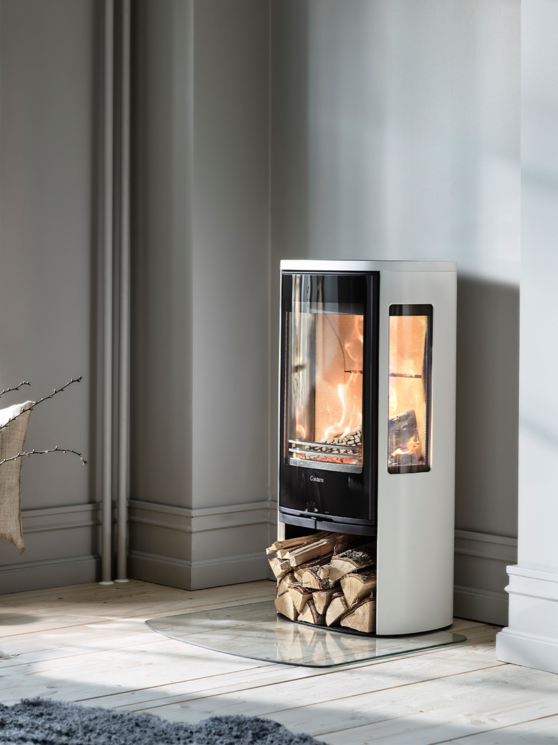 Side view of the Contura 856G wood burning stove showcasing its glass door and sleek design.