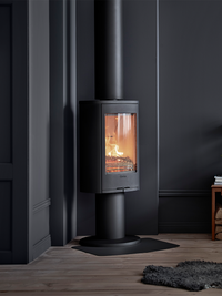 Contura 870 wood burning stove in black cast iron with pedestal base, showcasing the fire and optional turntable.