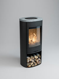 Side view of the Contura 910 wood burning stove with a cast iron door and soapstone top, showcasing its compact design.