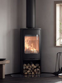 Contura 910 wood burning stove in black cast iron with a clean design and large glass door, showcasing its compact size.