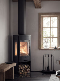 Side view of the Contura 956 wood burning stove showcasing its cast iron door and large glass panels.