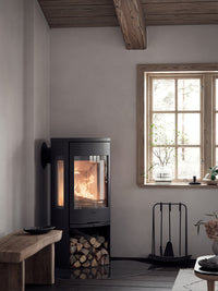 Side view of Contura 956 wood burning stove with cast iron door and large glass panels showcasing the fire.