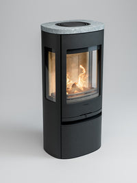 Side view of Contura 956 wood burning stove showcasing cast iron door and large glass panels for fire visibility.