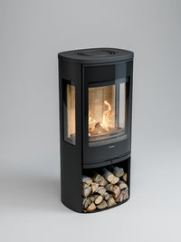 Side view of Contura 956G wood burning stove with glass door and painted aluminium top, showcasing flames and design details.